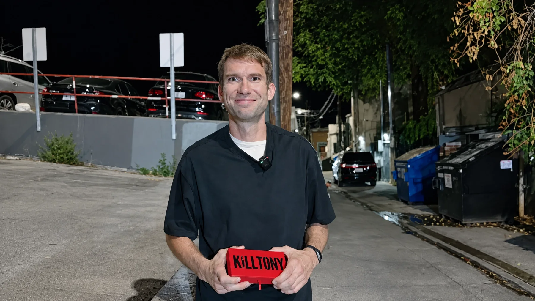 Shane Camp outside in an alley with the Golden Ticket box